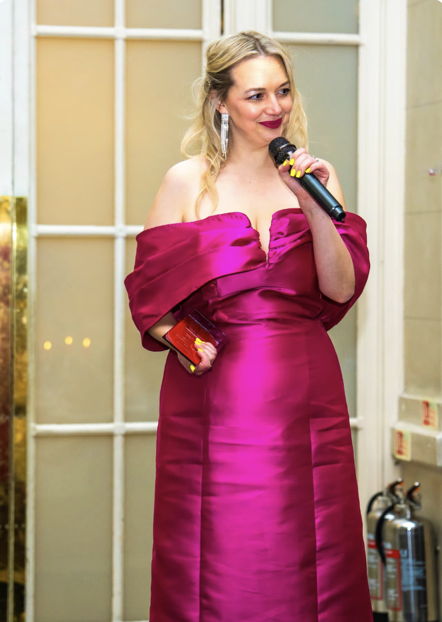 Winner holding her trophy at the 2025 Solopreneur Awards